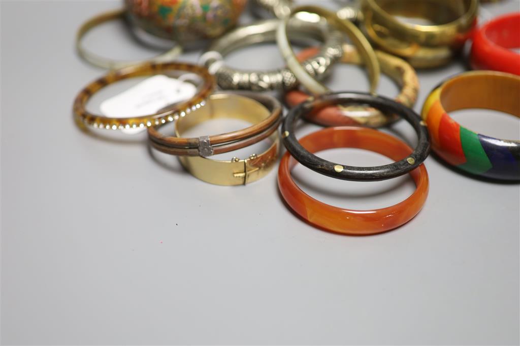A collection of bangles, including five ethnic white metal examples,